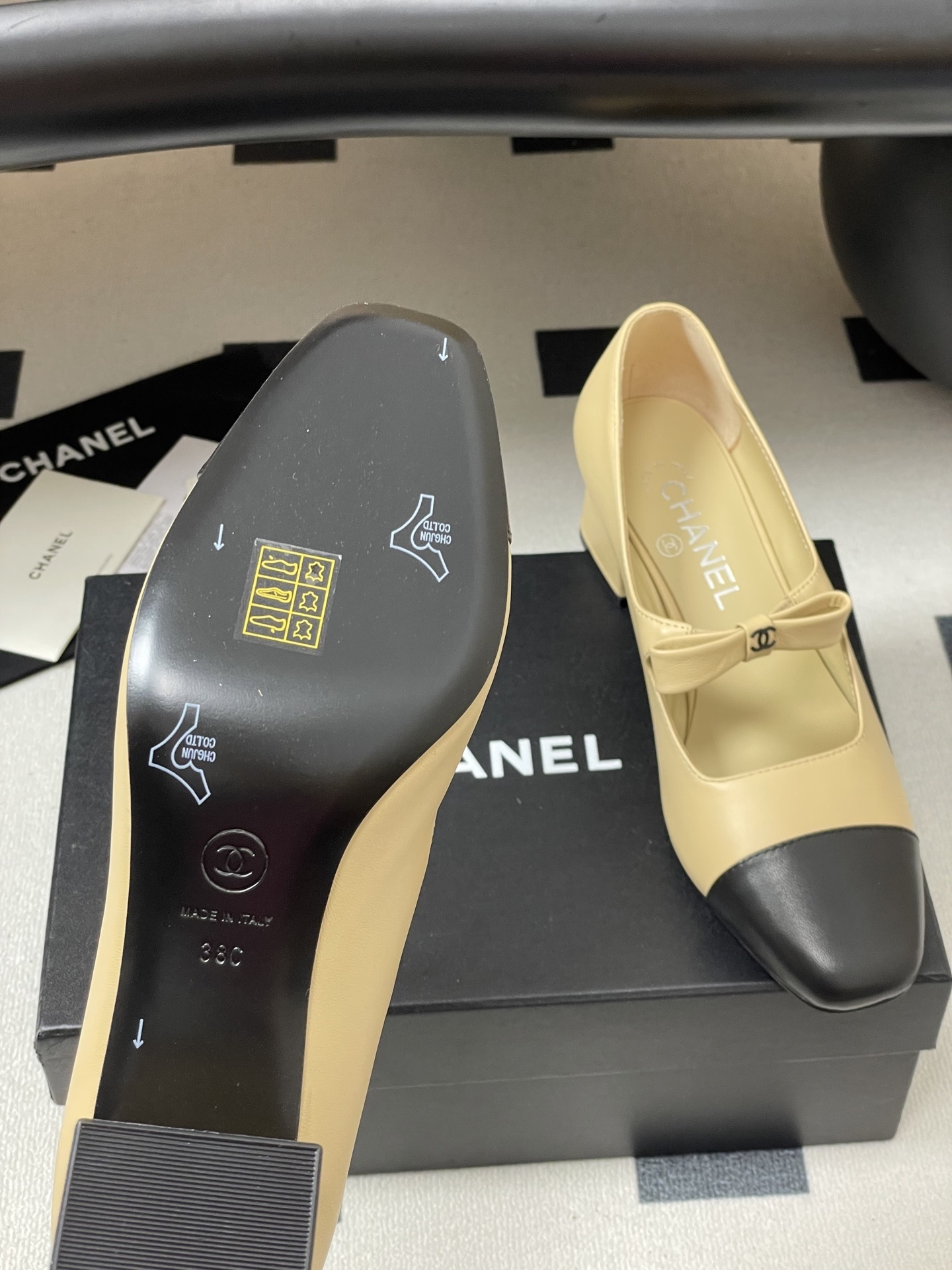 A pair of luxury Chanel beige leather Mary Jane pumps with black toe caps and CC logo bow details. - Hình 8