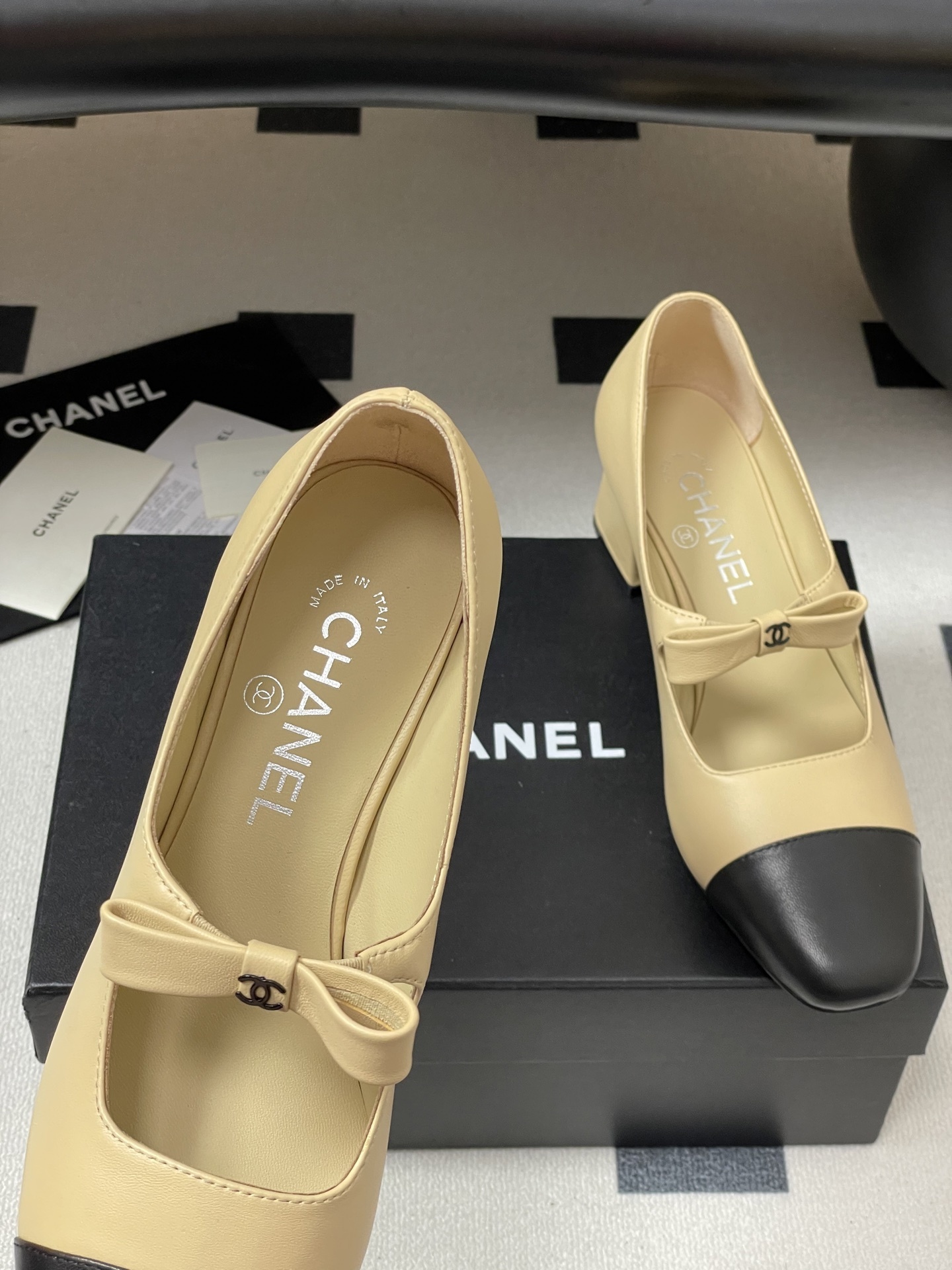 A pair of luxury Chanel beige leather Mary Jane pumps with black toe caps and CC logo bow details. - Hình 7