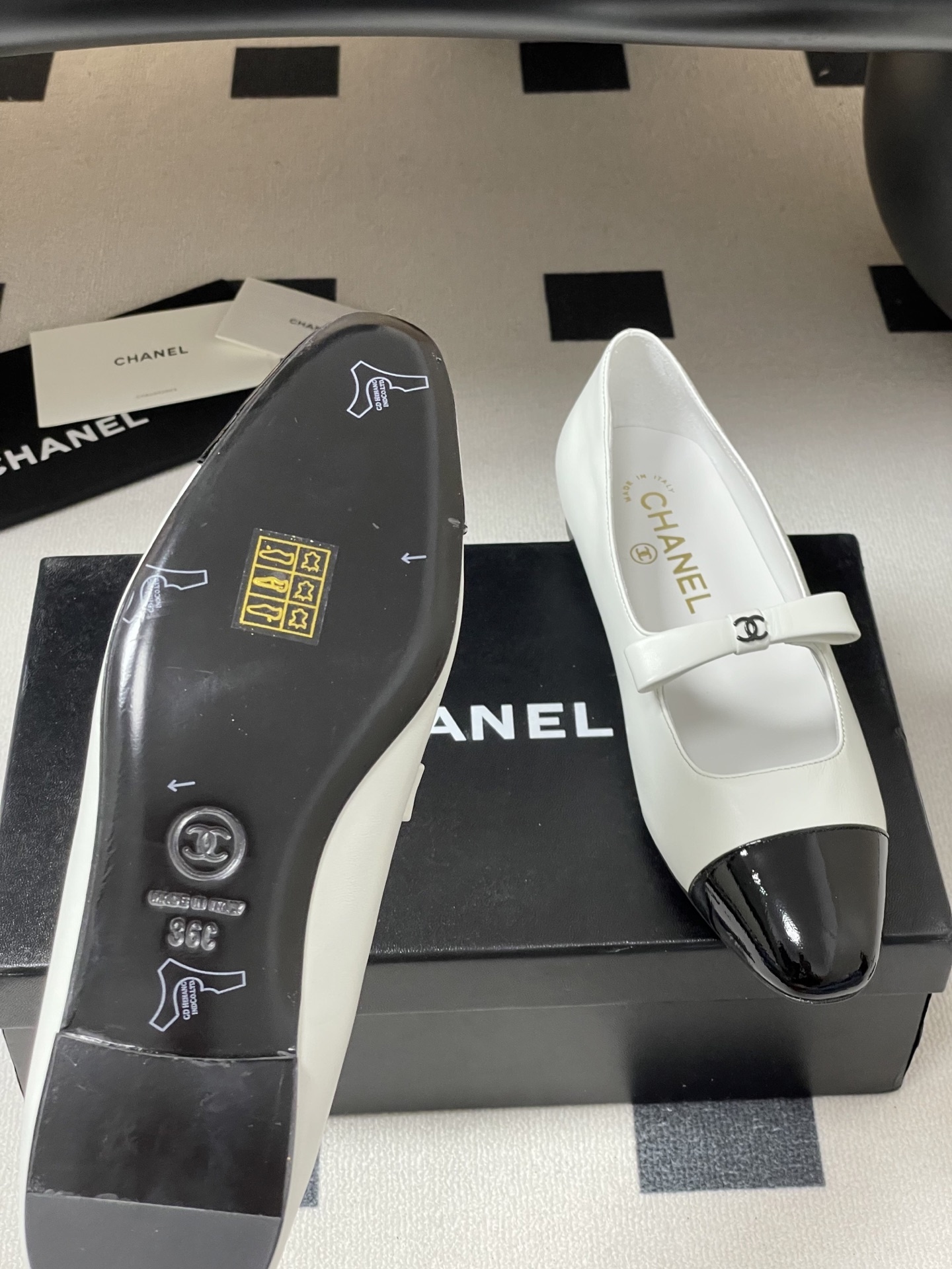 Pair of Chanel white leather Mary Jane flats with black patent leather cap toes and CC logo straps. - Hình 9