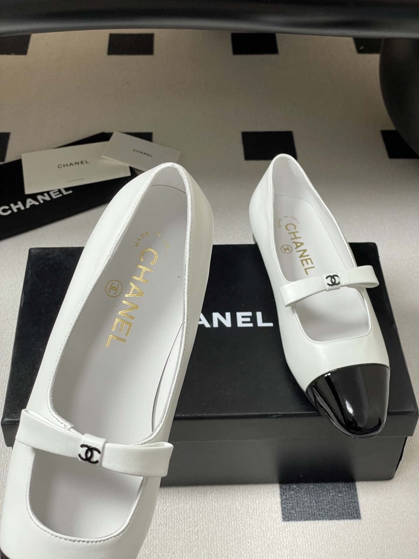 Pair of Chanel white leather Mary Jane flats with black patent leather cap toes and CC logo straps. - Hình 8