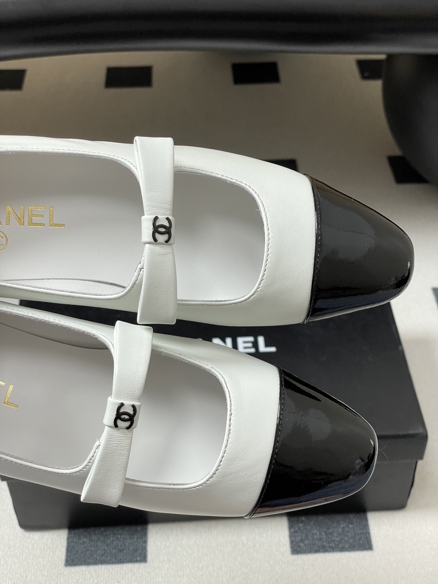 Pair of Chanel white leather Mary Jane flats with black patent leather cap toes and CC logo straps. - Hình 7