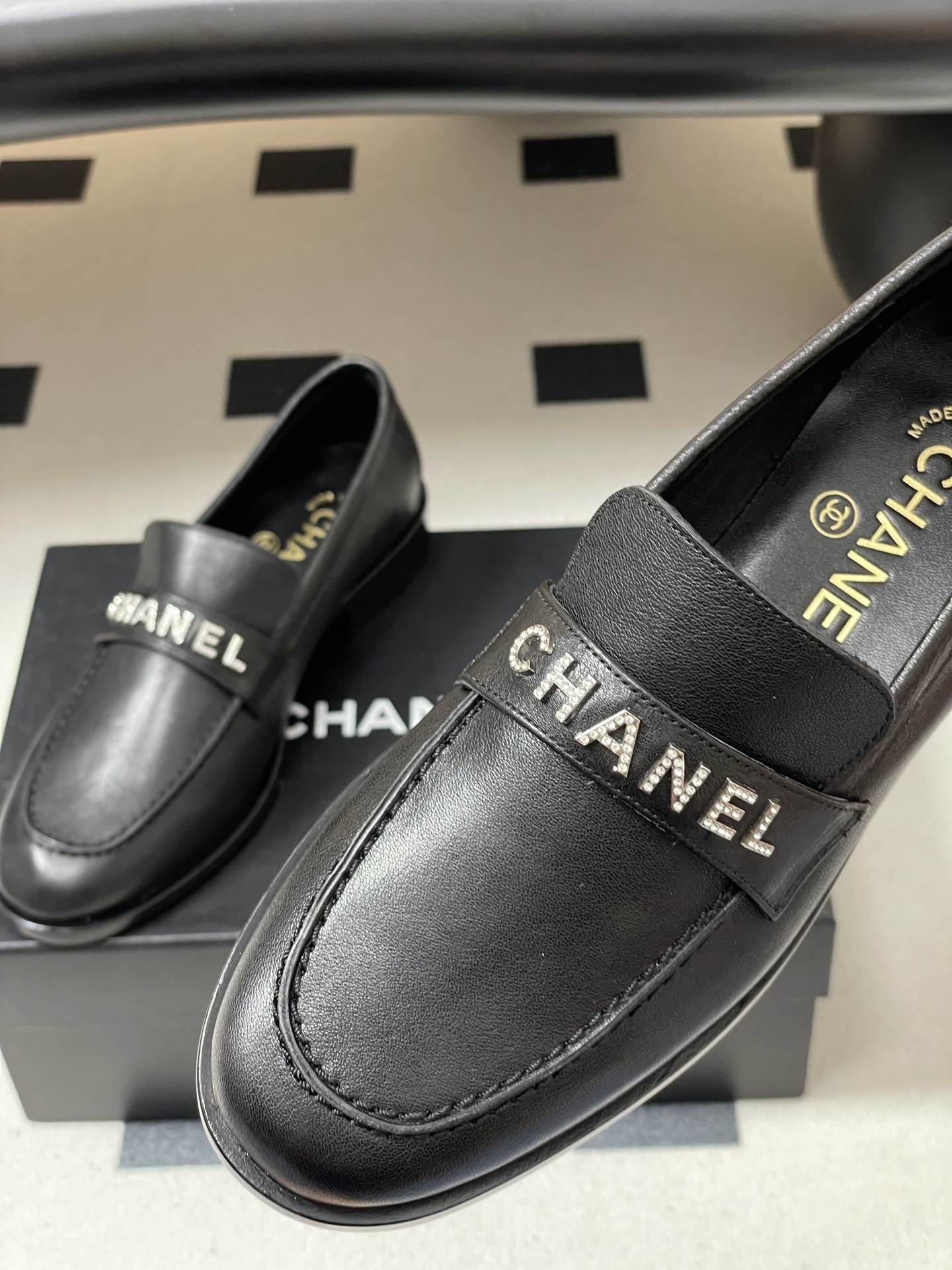 Pair of black leather Chanel loafers with crystal-embellished logo on the strap - Hình 9