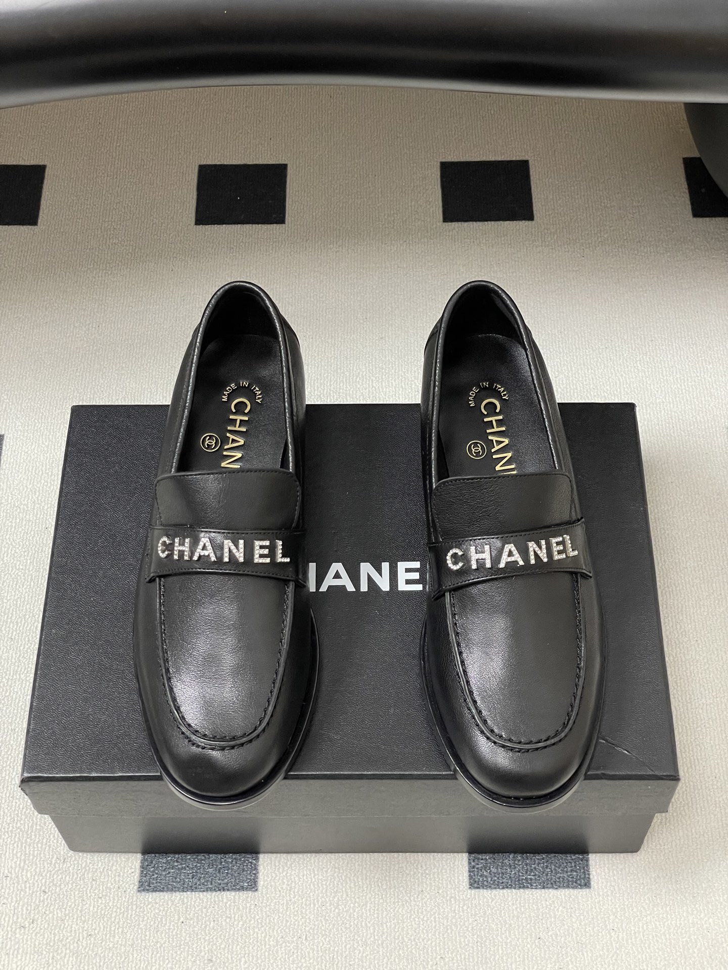 Pair of black leather Chanel loafers with crystal-embellished logo on the strap - Hình 5