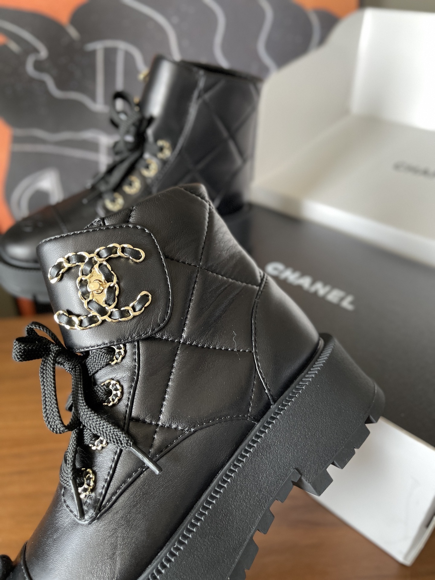 Chanel black quilted leather combat boots with gold CC logo and chunky lug sole - Hình 8