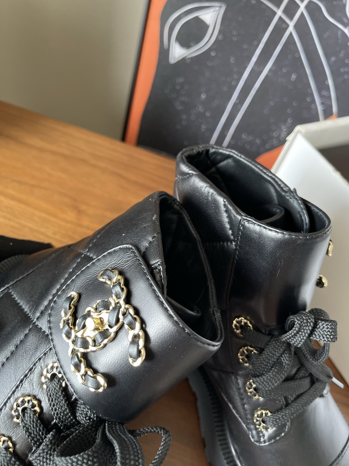 Chanel black quilted leather combat boots with gold CC logo and chunky lug sole - Hình 5