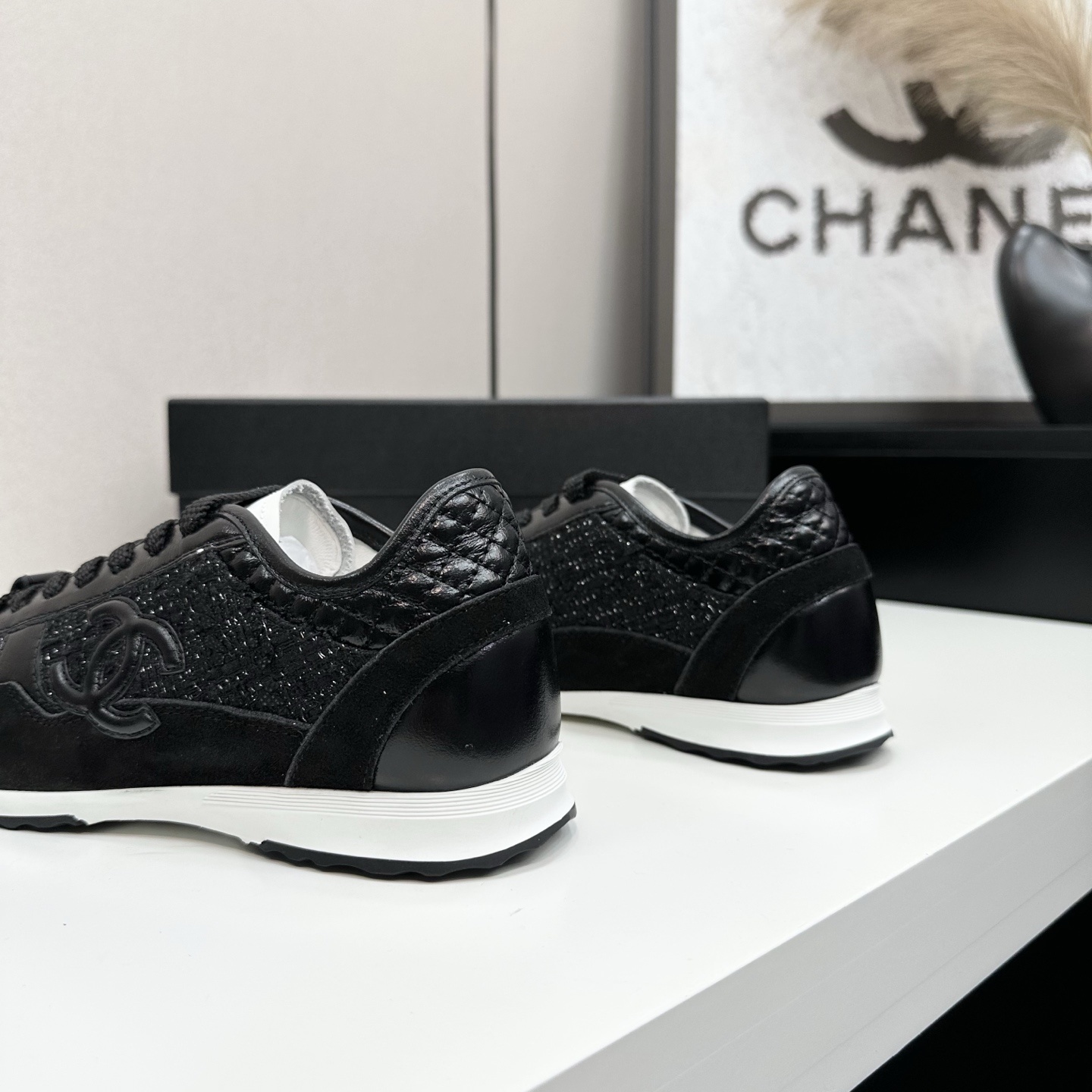 Side view of Chanel black sneakers with tweed and suede details on a black box - Hình 7