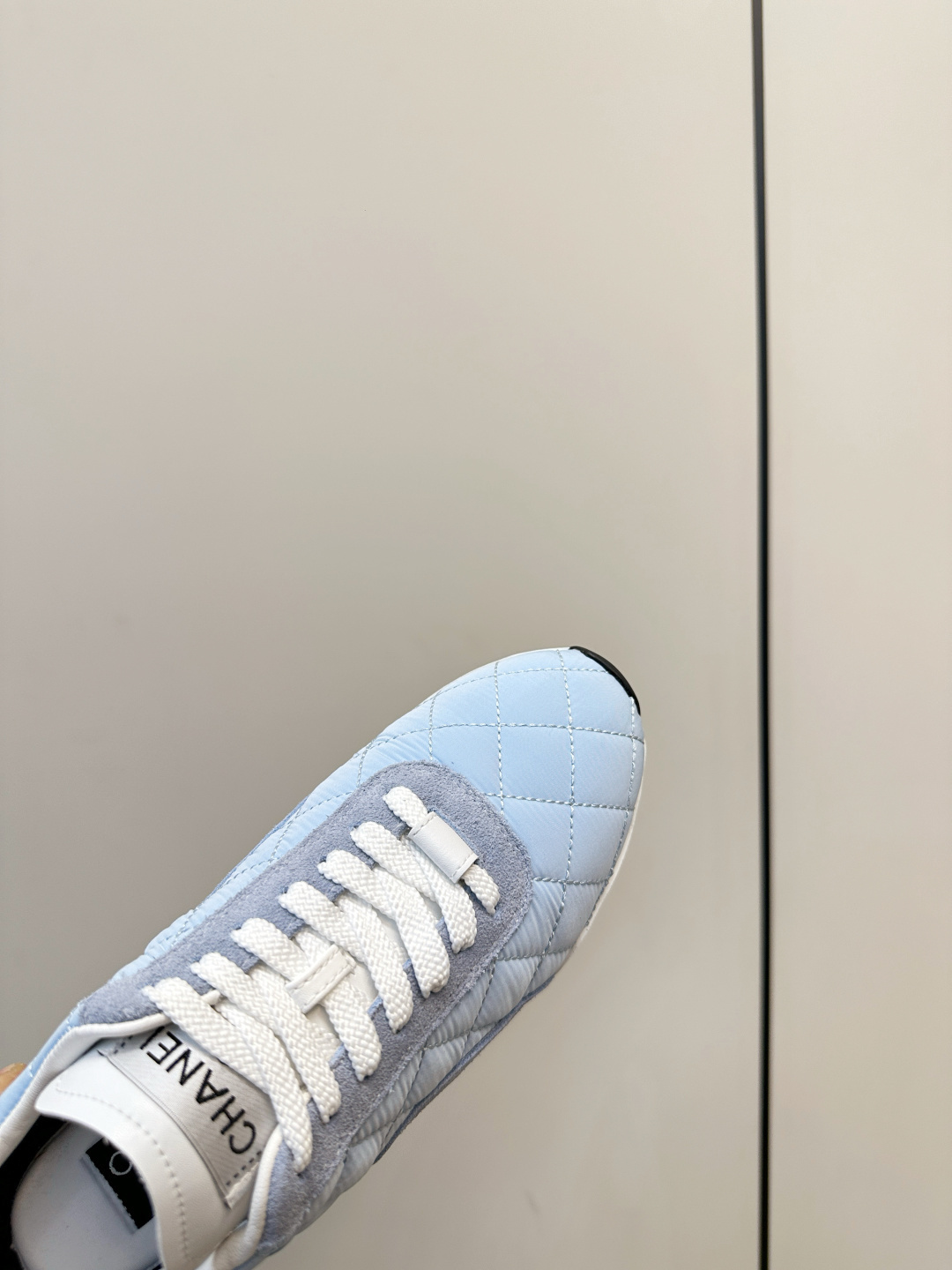 Luxury Chanel light blue quilted fabric and suede sneakers with white laces and CC logo on a black designer box. - Hình 7