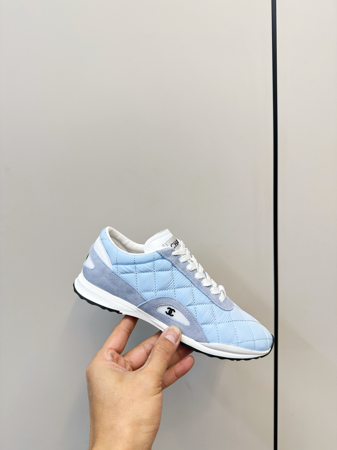 Luxury Chanel light blue quilted fabric and suede sneakers with white laces and CC logo on a black designer box. - Hình 6