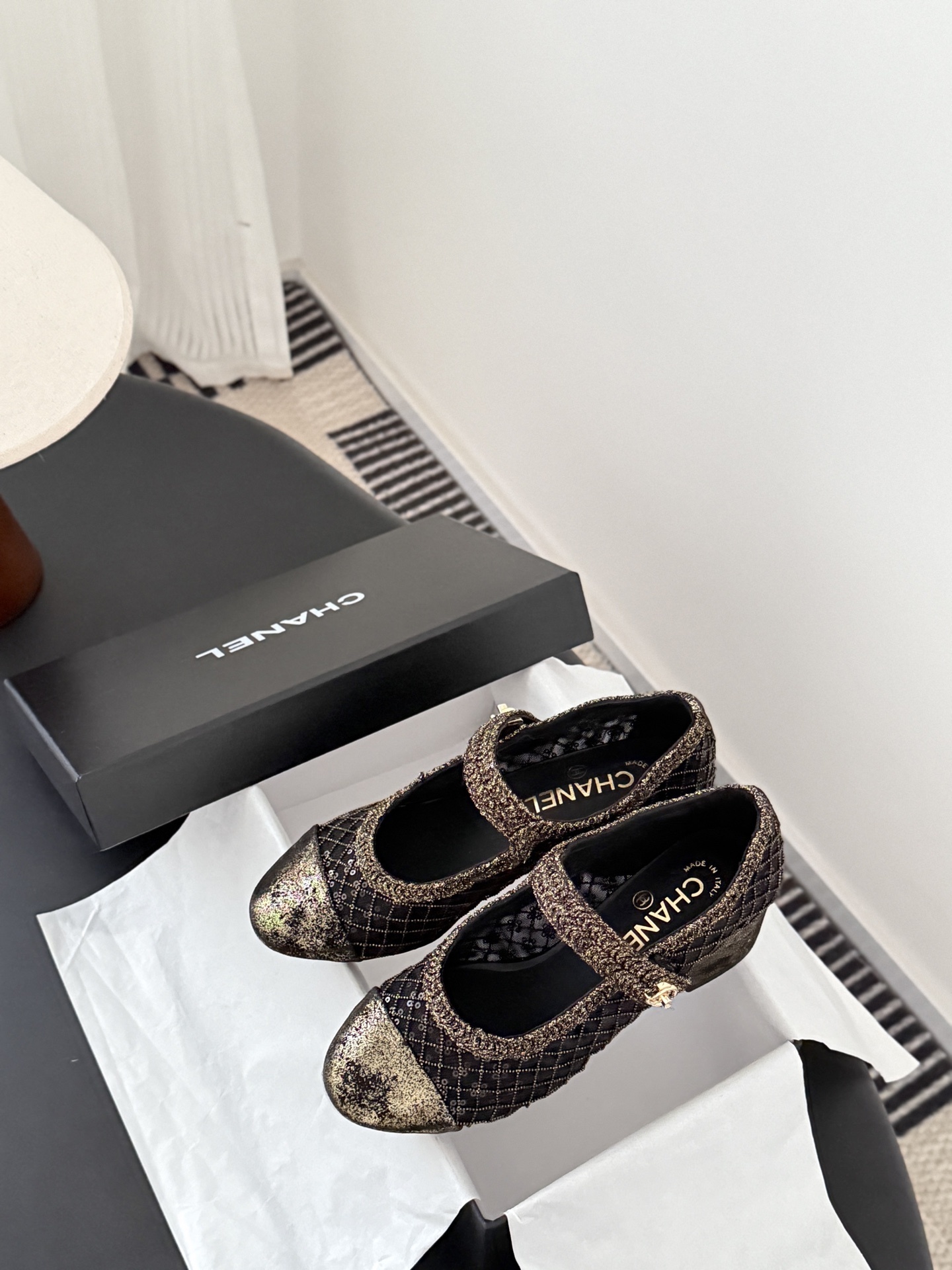 A pair of Chanel black mesh Mary Jane pumps with gold glitter quilted pattern and CC logo button detail shown with original box. - Hình 9