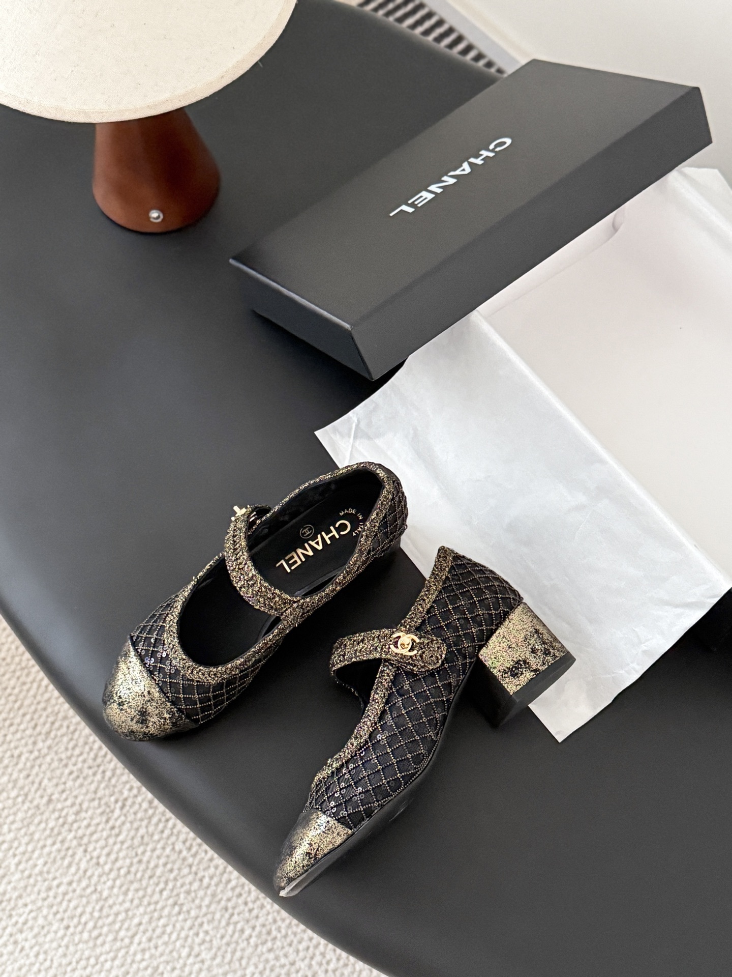 A pair of Chanel black mesh Mary Jane pumps with gold glitter quilted pattern and CC logo button detail shown with original box. - Hình 4