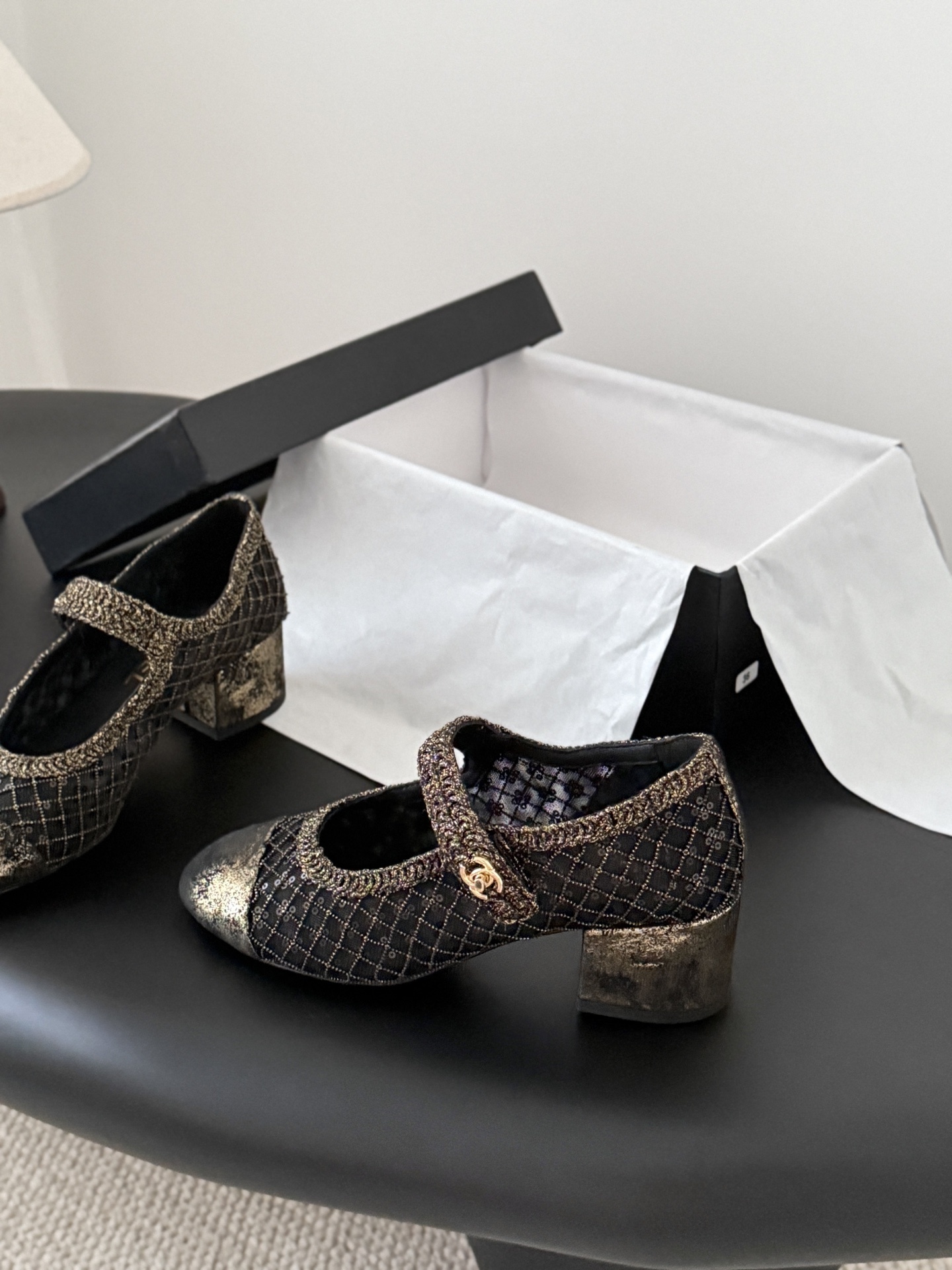 A pair of Chanel black mesh Mary Jane pumps with gold glitter quilted pattern and CC logo button detail shown with original box. - Hình 2