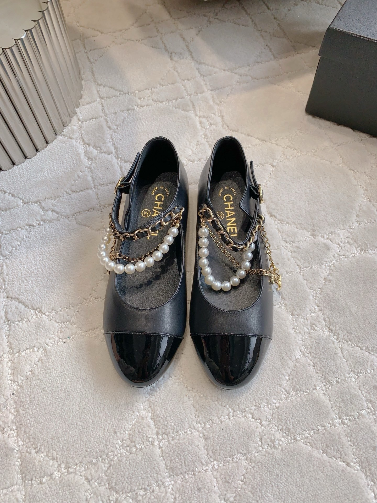 Luxury Chanel black leather Mary Jane flats with patent toe and pearl chain embellishments. - Hình 2