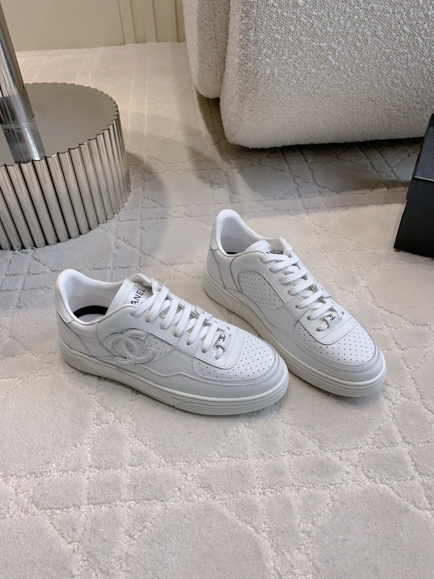 Pair of premium white Chanel calfskin leather sneakers with CC logo and perforated detailing. - Hình 3