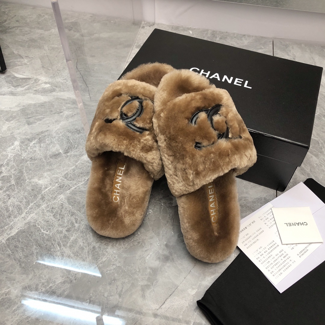 A pair of luxury tan Chanel shearling fur slides with black CC logo, displayed with original box and authenticity card. - Hình 8