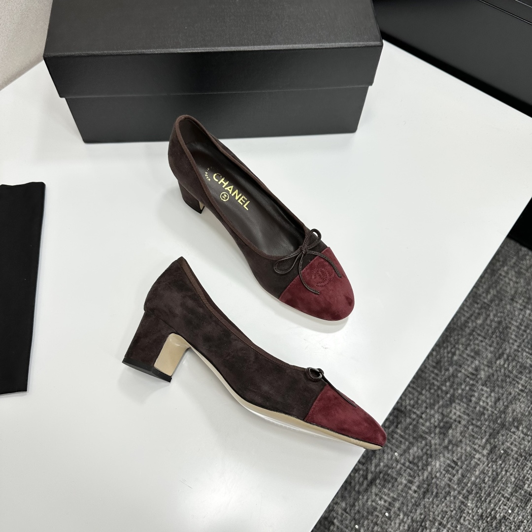 A pair of elegant two-tone suede block heel pumps in mocha brown and burgundy red with a small bow detail, displayed on a black shoe box. - Hình 7