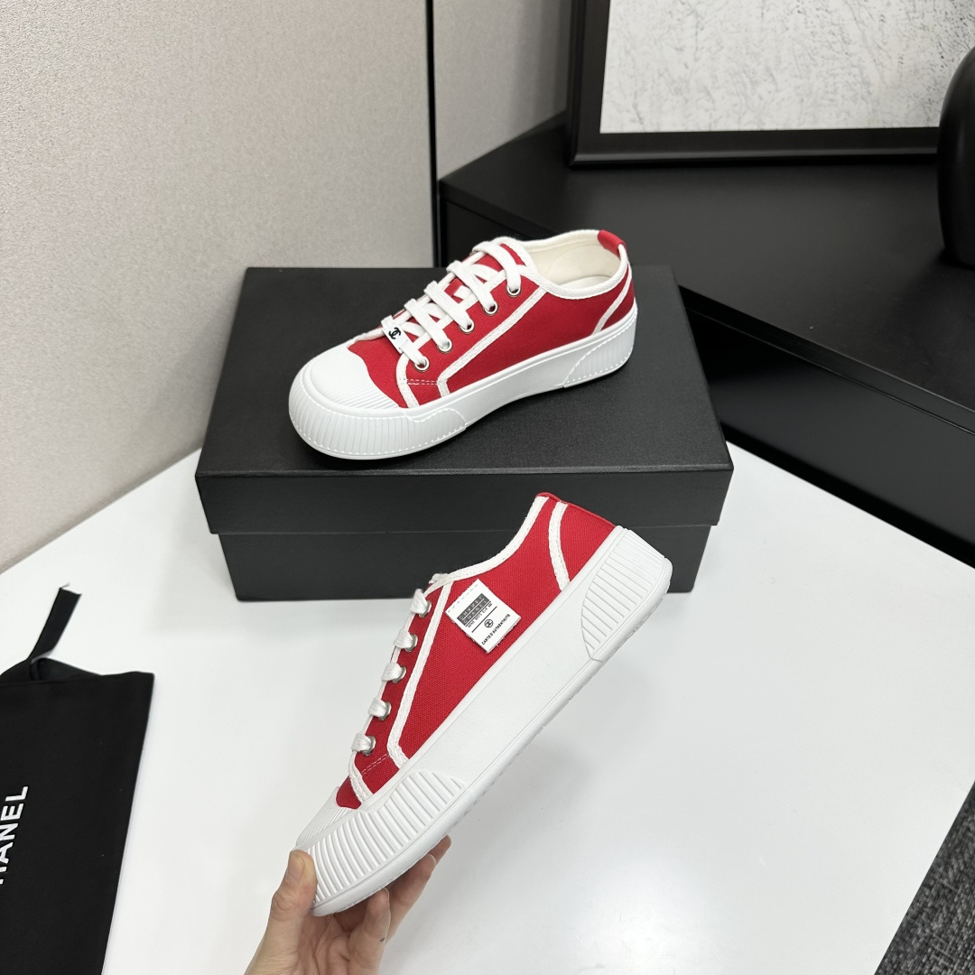 Pair of red canvas low-top sneakers with thick white platform soles and white laces - Hình 3