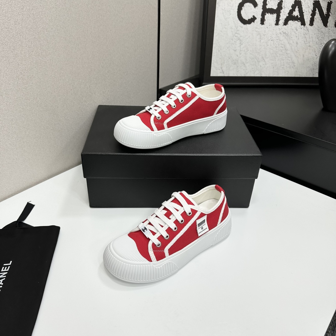 Pair of red canvas low-top sneakers with thick white platform soles and white laces - Hình 2