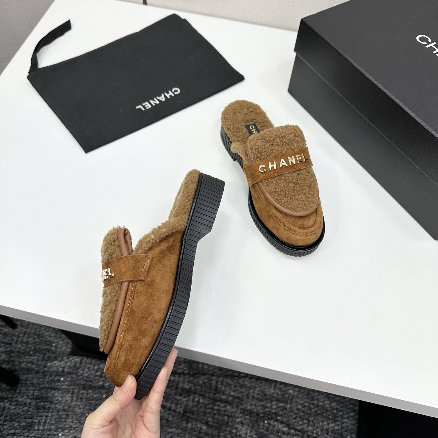 Luxury Chanel camel suede mules with shearling lining and gold-tone logo lettering on a black platform sole. - Hình 8