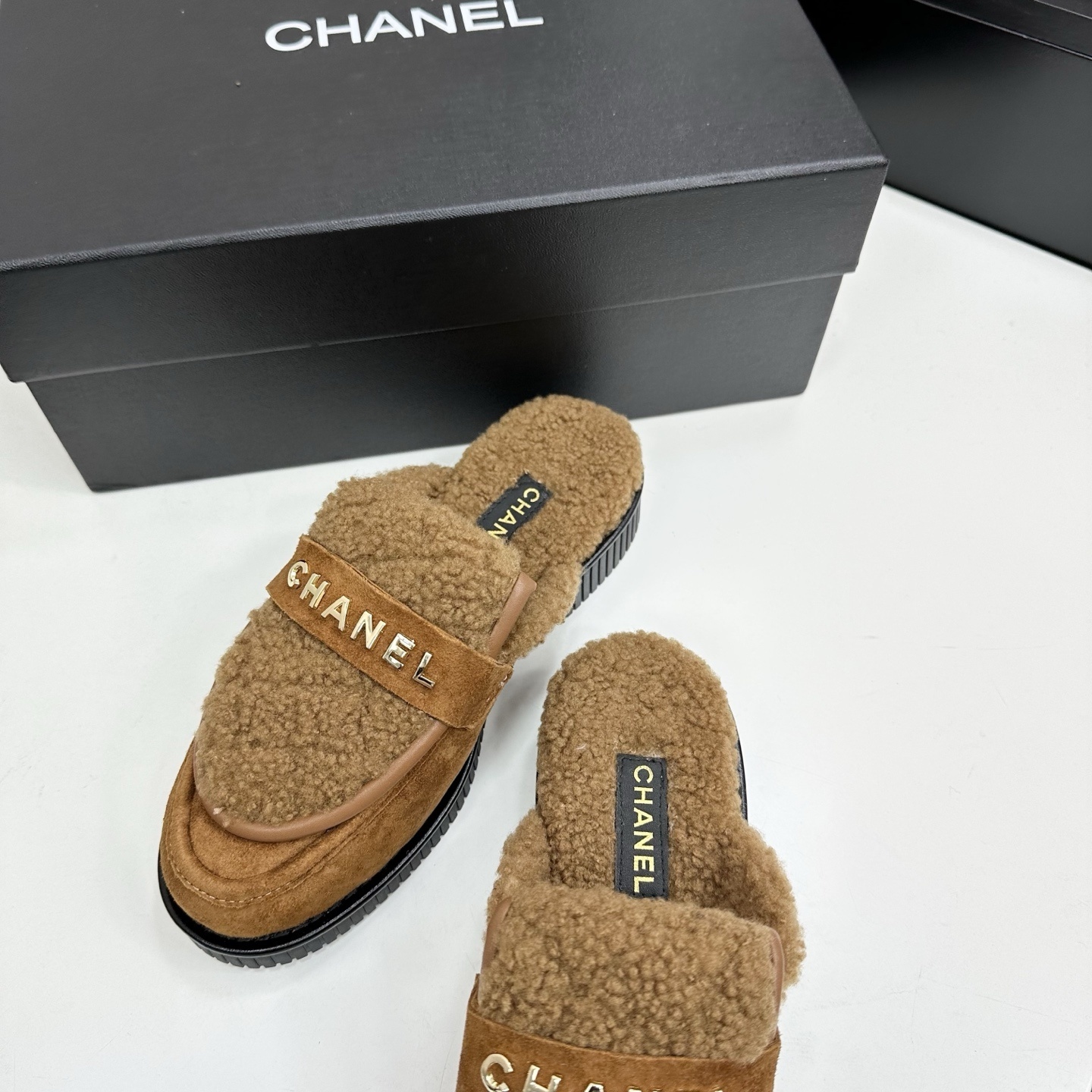 Luxury Chanel camel suede mules with shearling lining and gold-tone logo lettering on a black platform sole. - Hình 7