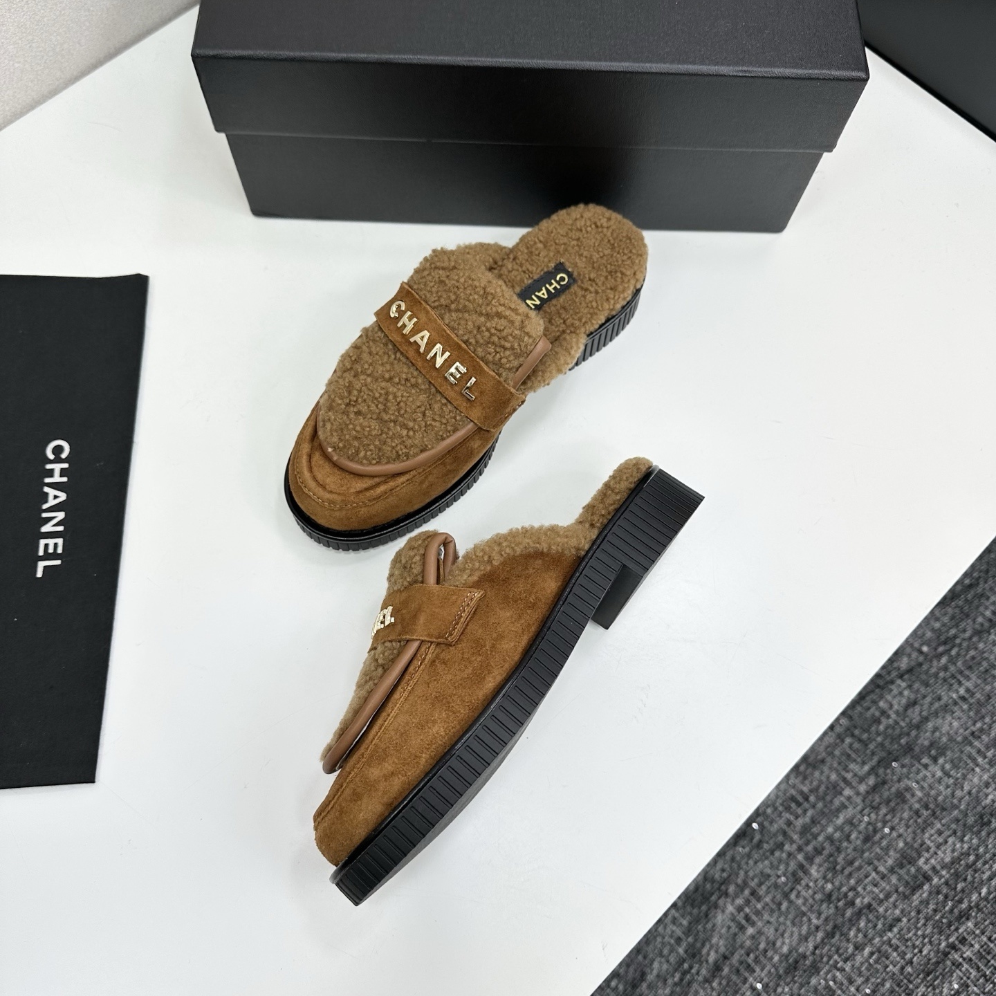 Luxury Chanel camel suede mules with shearling lining and gold-tone logo lettering on a black platform sole. - Hình 6