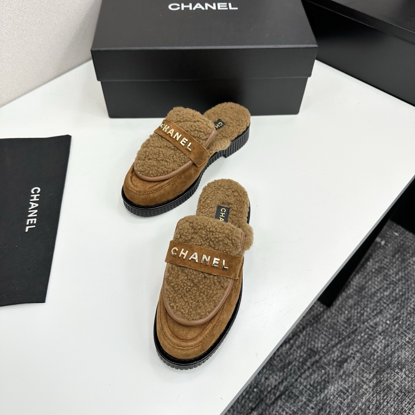Luxury Chanel camel suede mules with shearling lining and gold-tone logo lettering on a black platform sole. - Hình 5