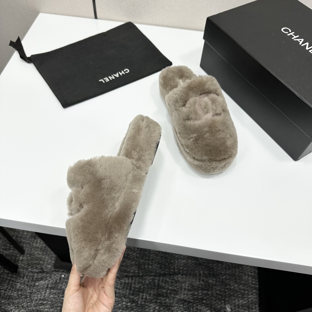 A pair of grey Chanel-inspired plush faux fur platform slippers displayed on a black designer box. - Hình 9
