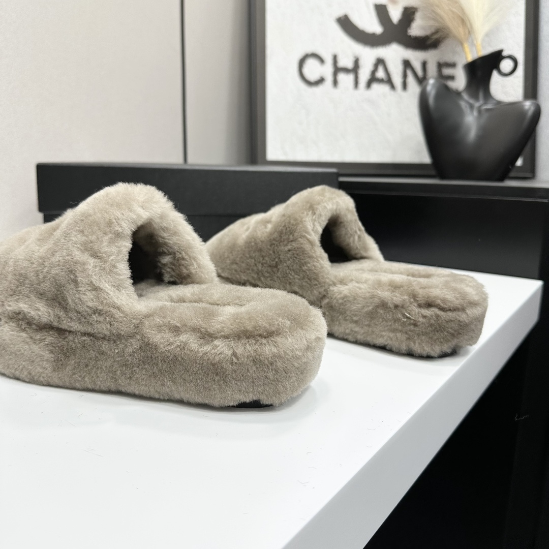 A pair of grey Chanel-inspired plush faux fur platform slippers displayed on a black designer box. - Hình 7
