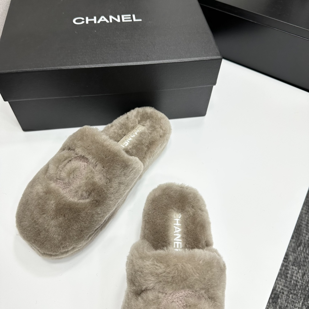 A pair of grey Chanel-inspired plush faux fur platform slippers displayed on a black designer box. - Hình 6