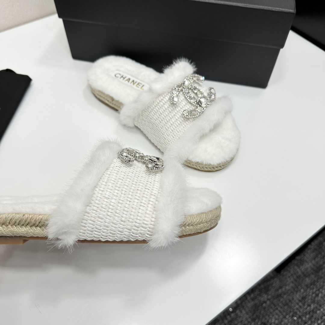 Pair of luxury white faux fur slides with crystal logo embellishment and espadrille soles on a black gift box - Hình 9