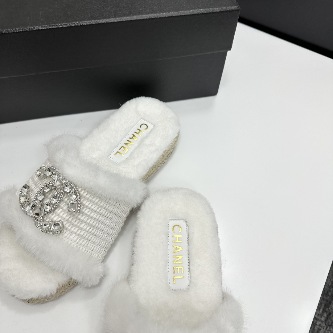 Pair of luxury white faux fur slides with crystal logo embellishment and espadrille soles on a black gift box - Hình 7
