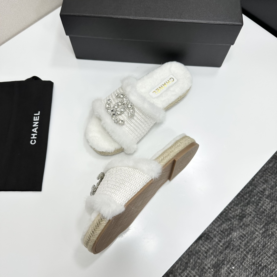 Pair of luxury white faux fur slides with crystal logo embellishment and espadrille soles on a black gift box - Hình 6