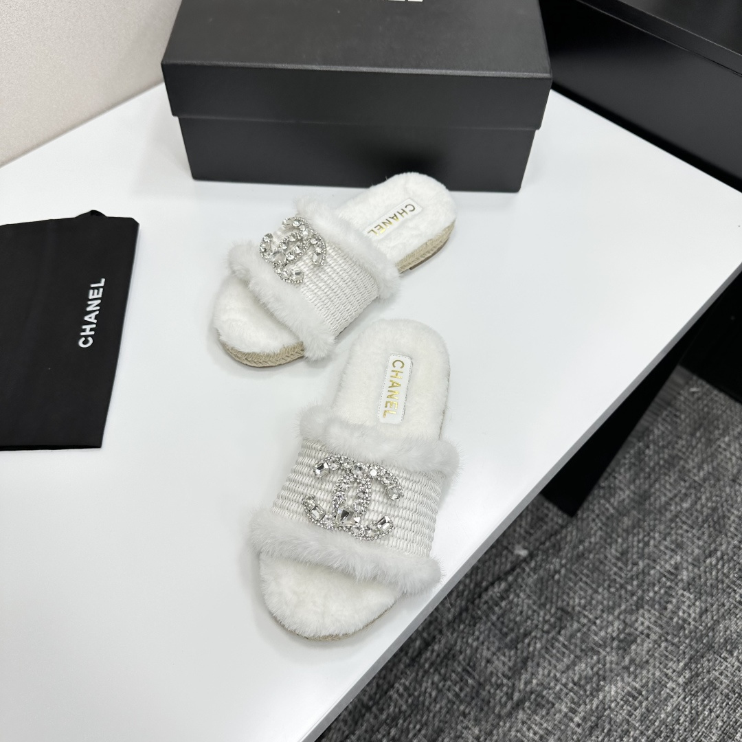 Pair of luxury white faux fur slides with crystal logo embellishment and espadrille soles on a black gift box - Hình 5