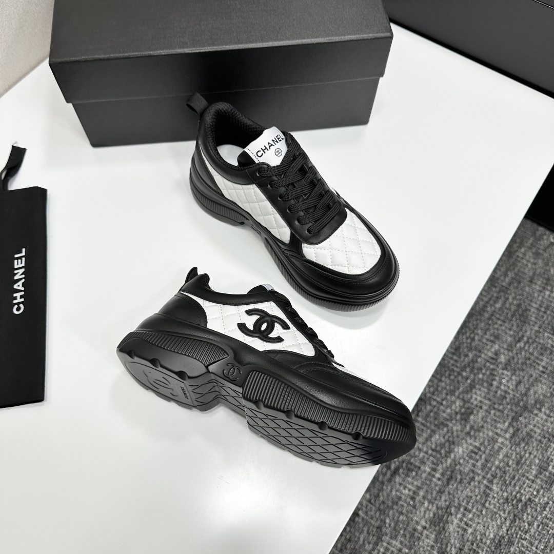 A pair of luxury Chanel black and white quilted leather sneakers with a chunky platform sole, displayed with original box and dust bag. - Hình 10
