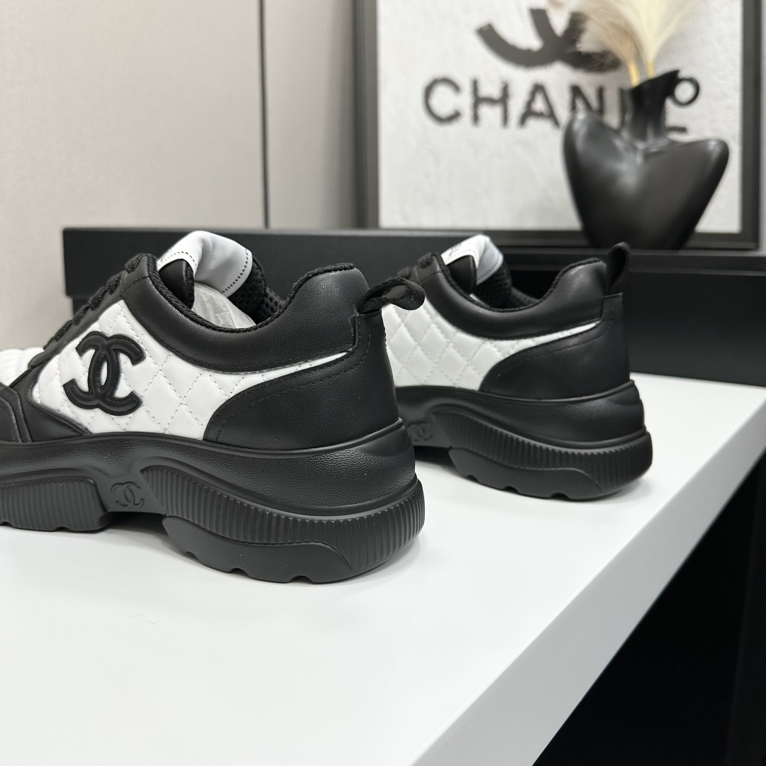 A pair of luxury Chanel black and white quilted leather sneakers with a chunky platform sole, displayed with original box and dust bag. - Hình 9
