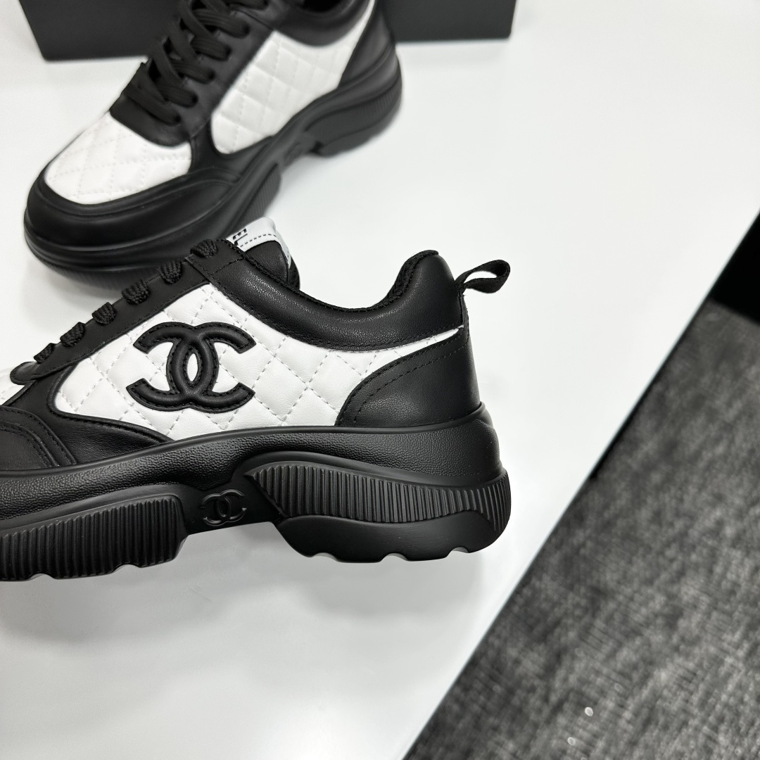 A pair of luxury Chanel black and white quilted leather sneakers with a chunky platform sole, displayed with original box and dust bag. - Hình 8