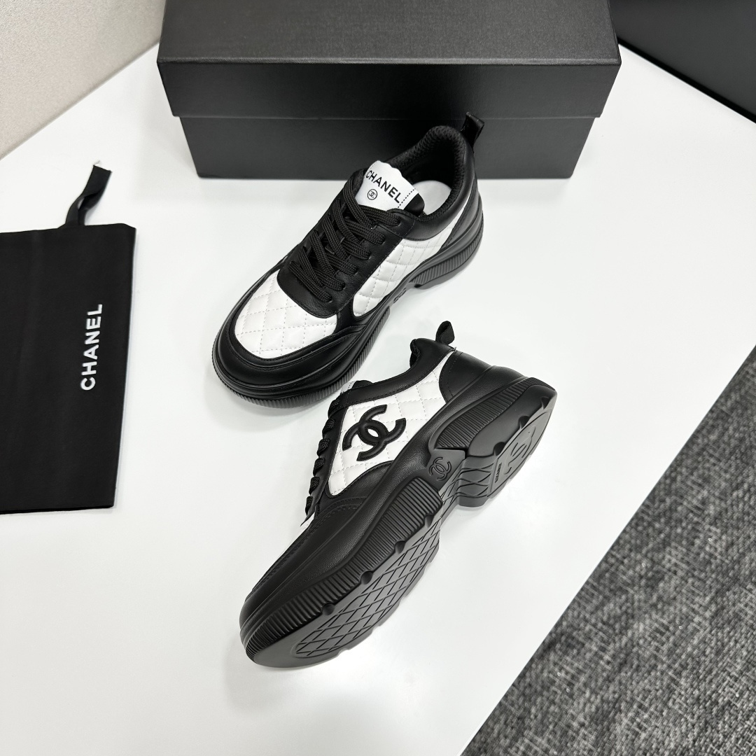 A pair of luxury Chanel black and white quilted leather sneakers with a chunky platform sole, displayed with original box and dust bag. - Hình 7