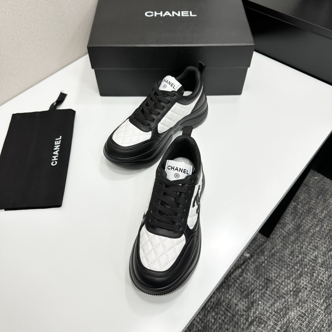 A pair of luxury Chanel black and white quilted leather sneakers with a chunky platform sole, displayed with original box and dust bag. - Hình 6