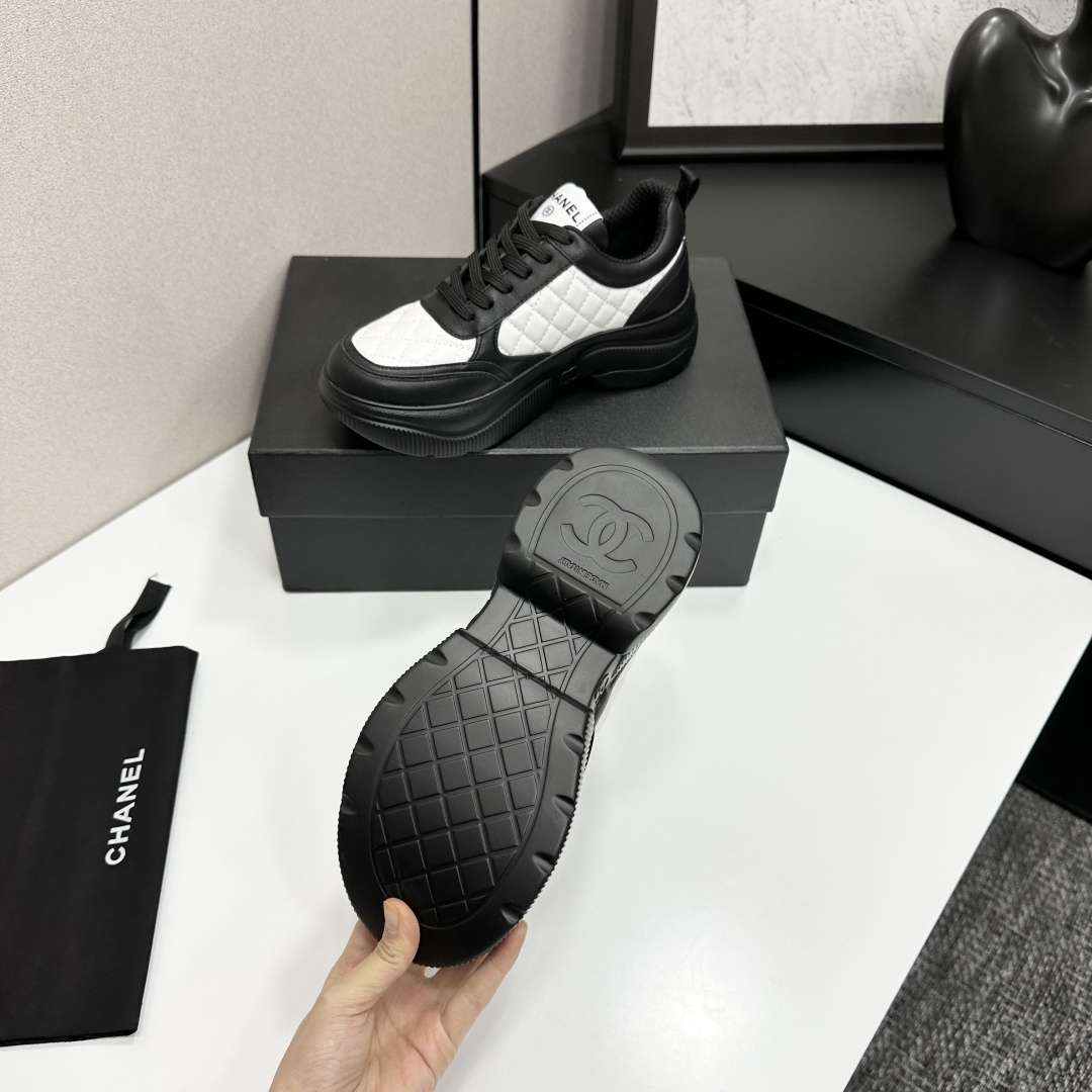 A pair of luxury Chanel black and white quilted leather sneakers with a chunky platform sole, displayed with original box and dust bag. - Hình 5