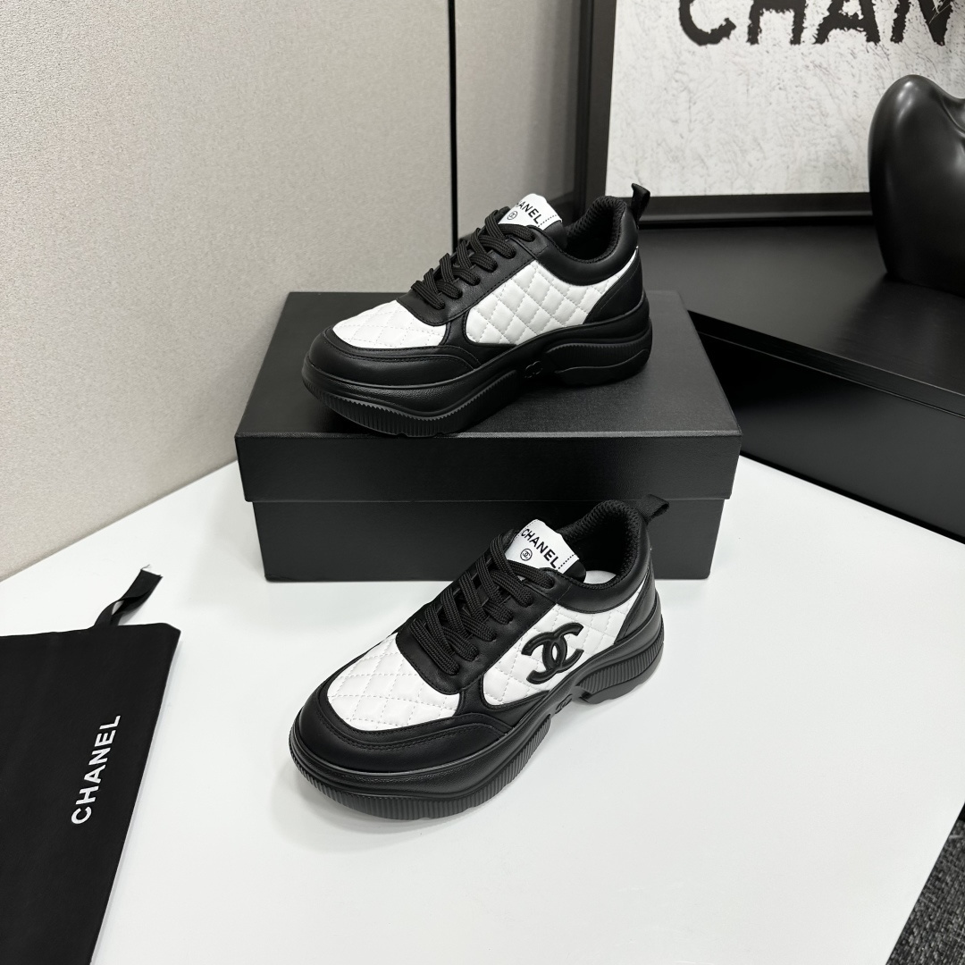 A pair of luxury Chanel black and white quilted leather sneakers with a chunky platform sole, displayed with original box and dust bag. - Hình 3