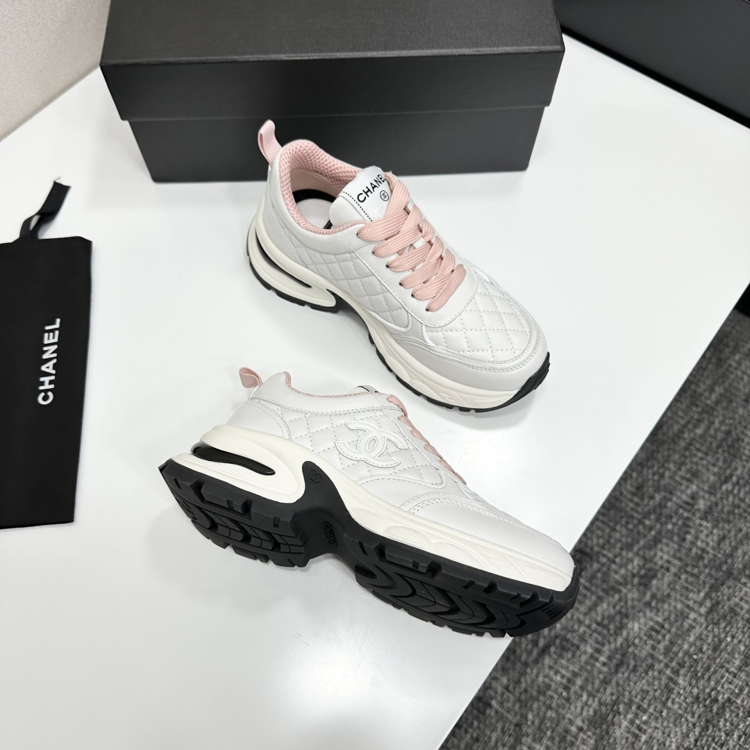 Pair of Chanel white quilted leather sneakers with pink laces and platform soles on a black box - Hình 9