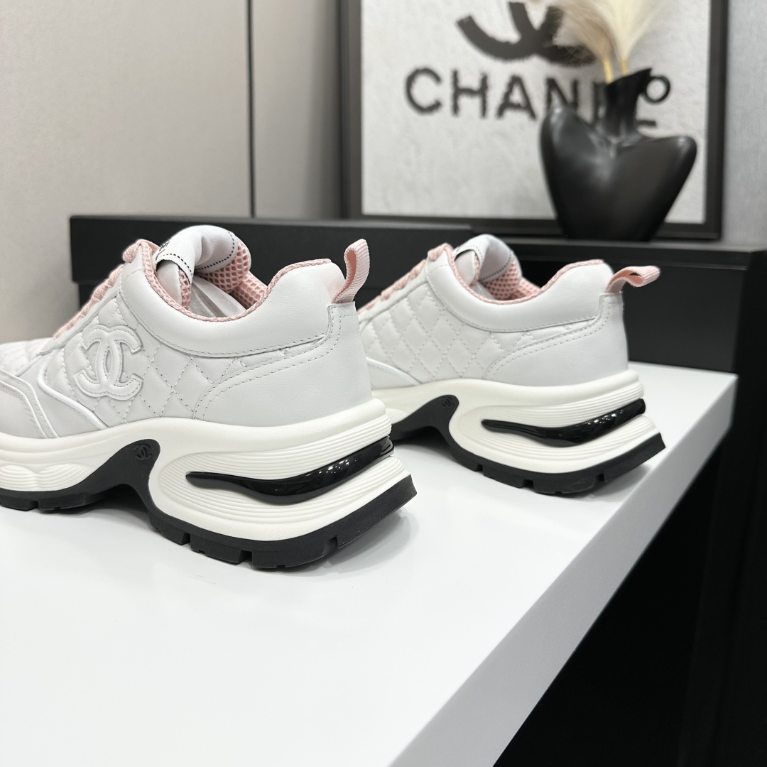 Pair of Chanel white quilted leather sneakers with pink laces and platform soles on a black box - Hình 8