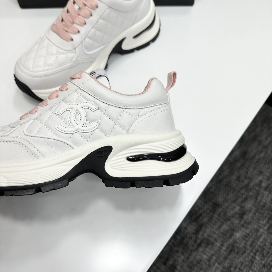 Pair of Chanel white quilted leather sneakers with pink laces and platform soles on a black box - Hình 7