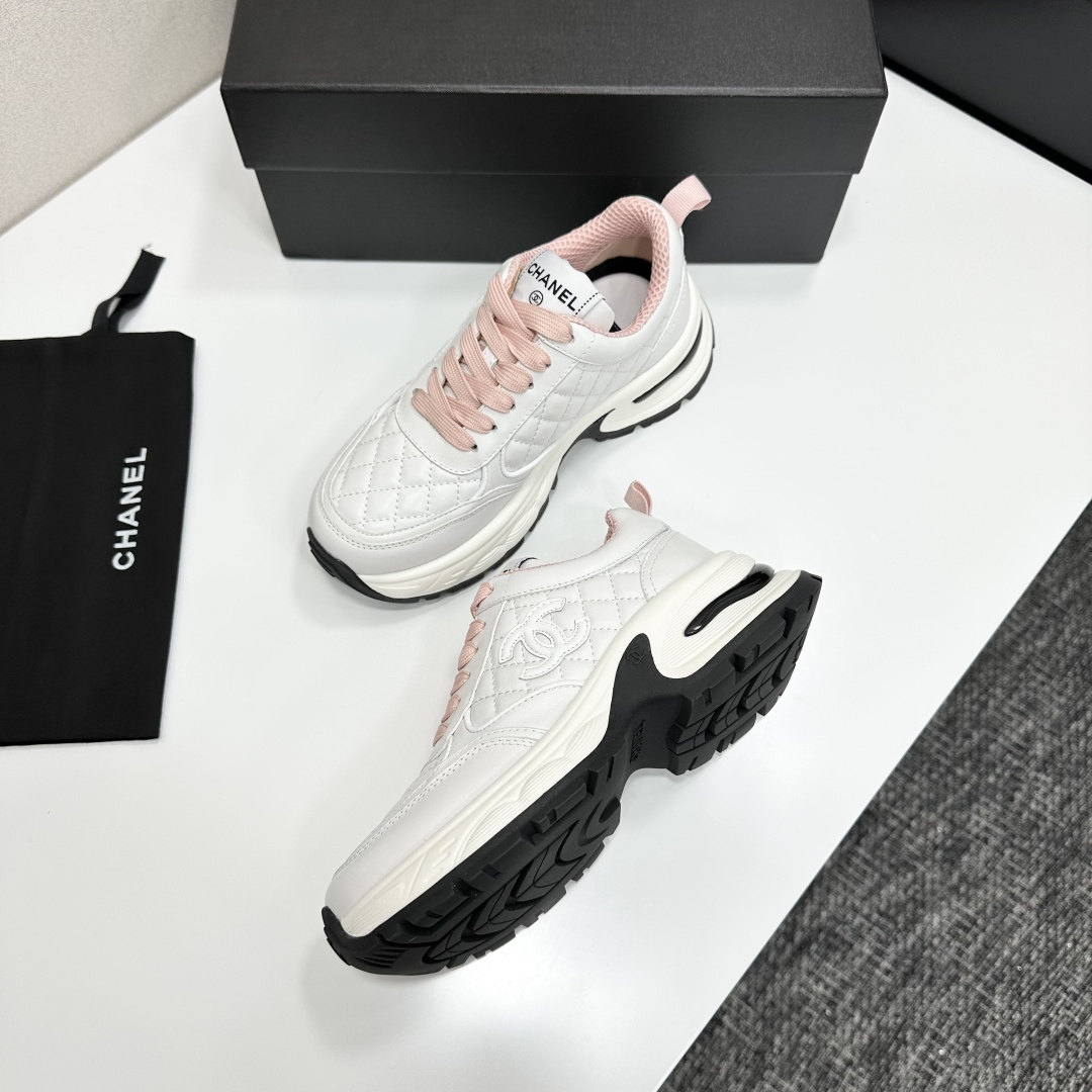 Pair of Chanel white quilted leather sneakers with pink laces and platform soles on a black box - Hình 6