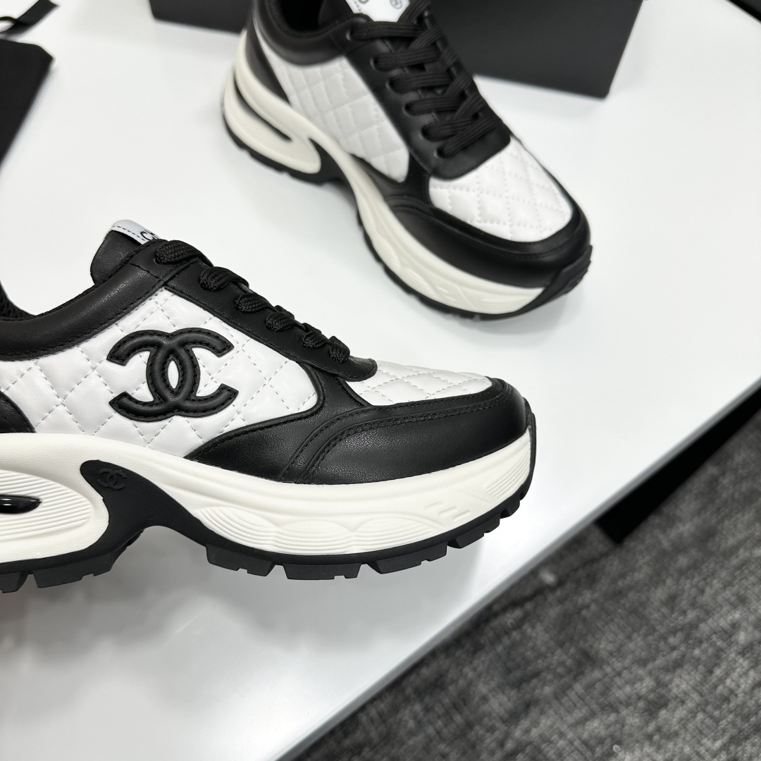 Side view of Chanel quilted leather sneakers in black and white featuring the iconic CC logo and chunky platform sole - Hình 10