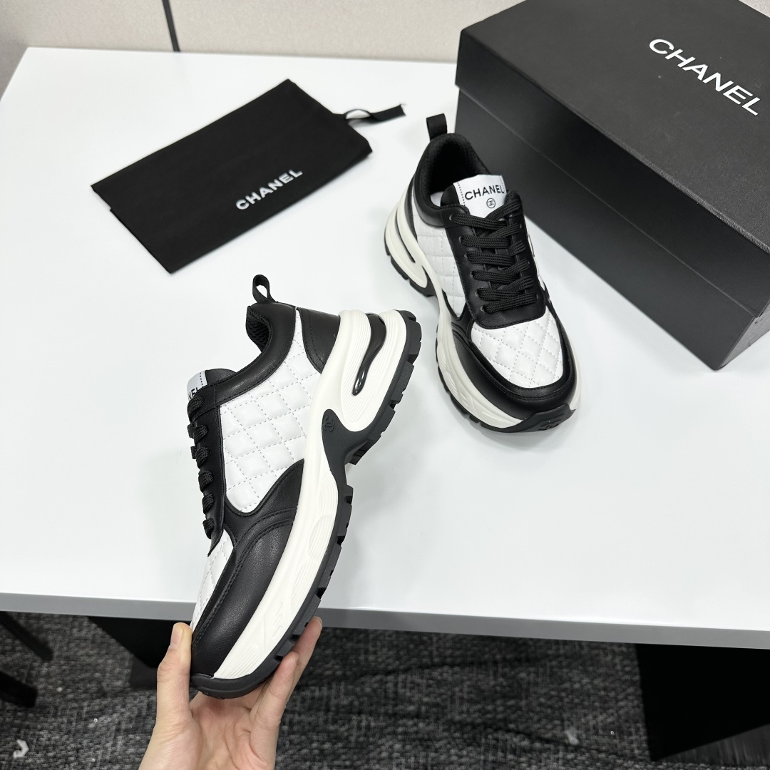 Side view of Chanel quilted leather sneakers in black and white featuring the iconic CC logo and chunky platform sole - Hình 9