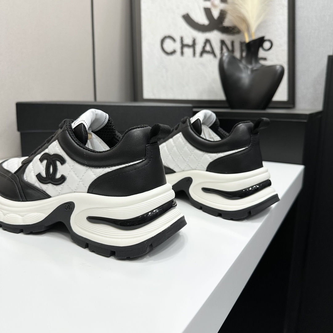 Side view of Chanel quilted leather sneakers in black and white featuring the iconic CC logo and chunky platform sole - Hình 8