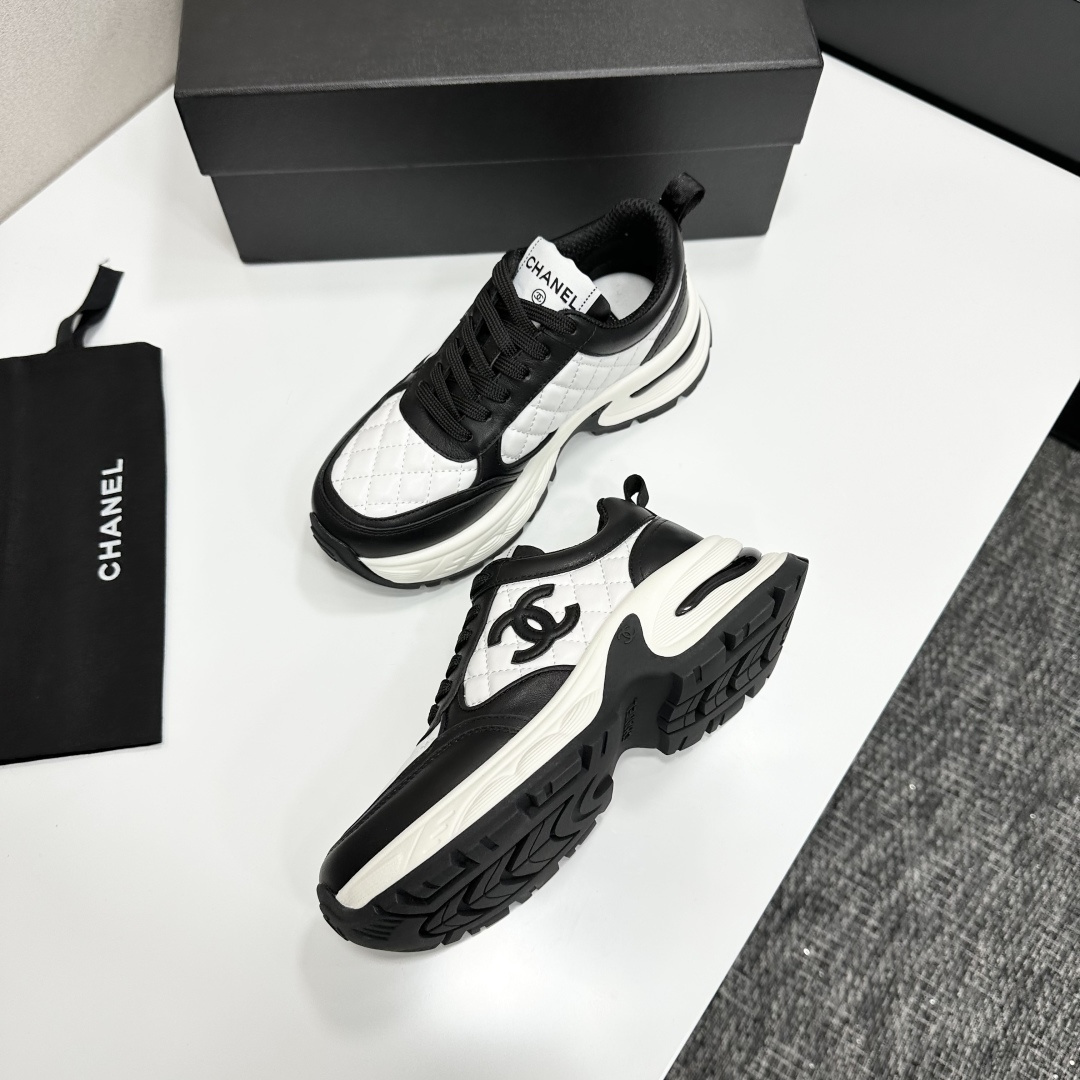 Side view of Chanel quilted leather sneakers in black and white featuring the iconic CC logo and chunky platform sole - Hình 6