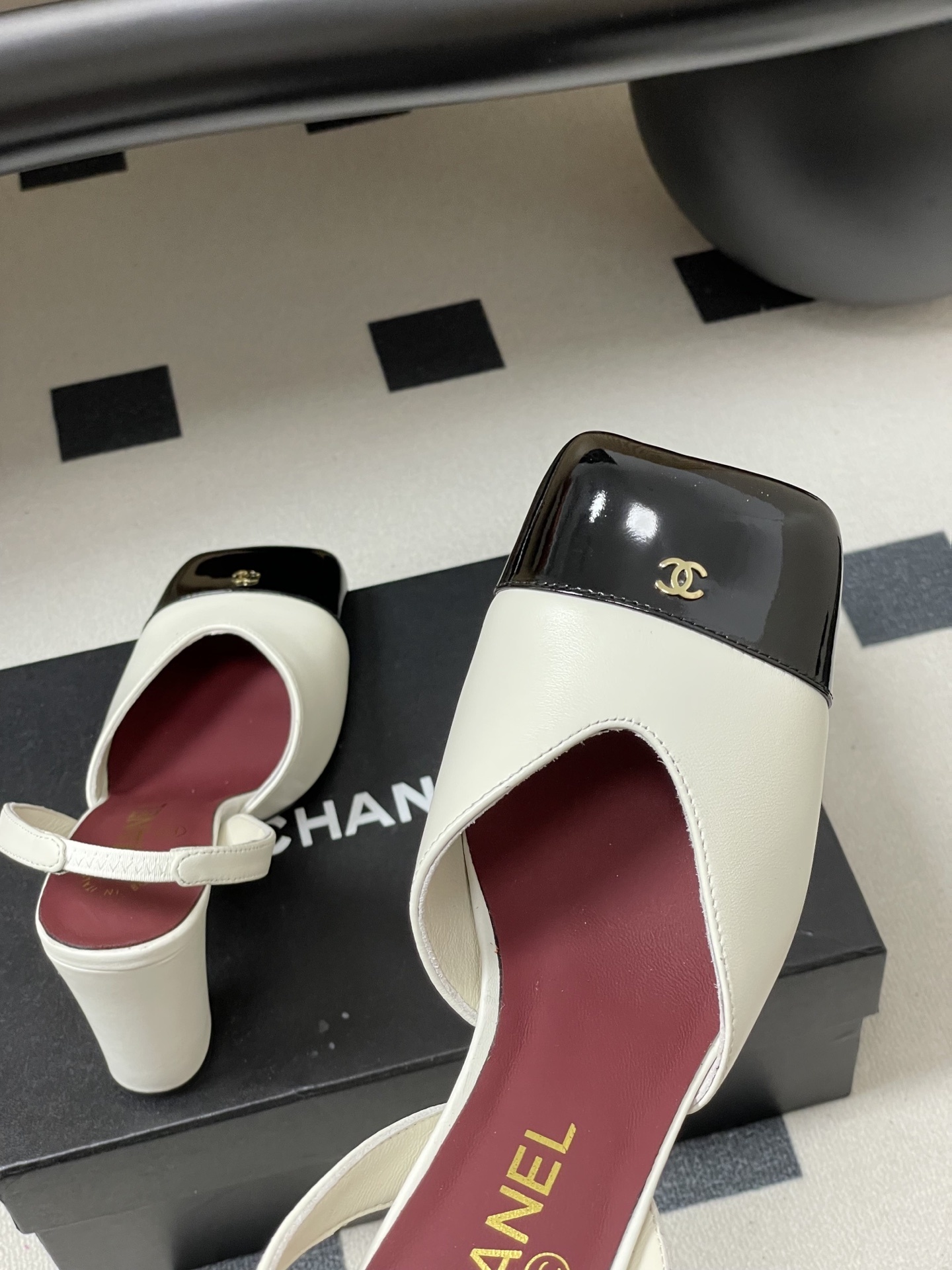 A pair of Chanel two-tone slingback pumps in white and black leather with a square toe and block heel - Hình 9