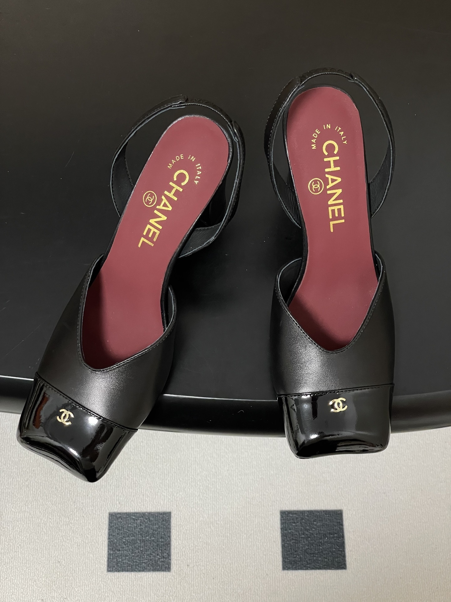 A pair of authentic Chanel black leather slingback pumps with square patent leather toes and gold CC logos - Hình 2