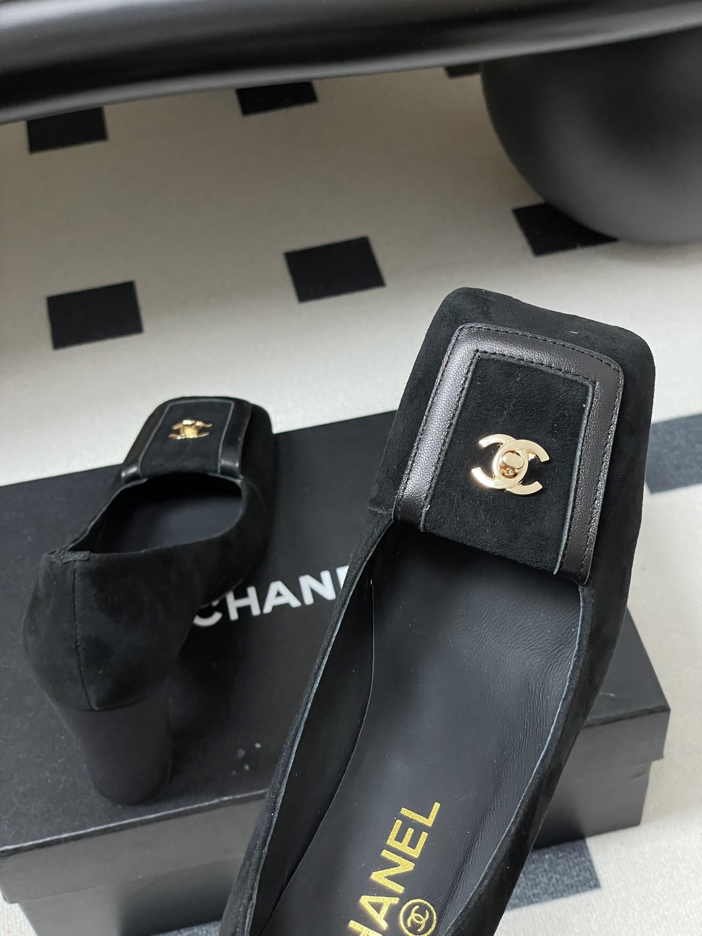 A pair of luxury Chanel black suede square-toe pumps featuring gold CC logo buckles and block heels. - Hình 9